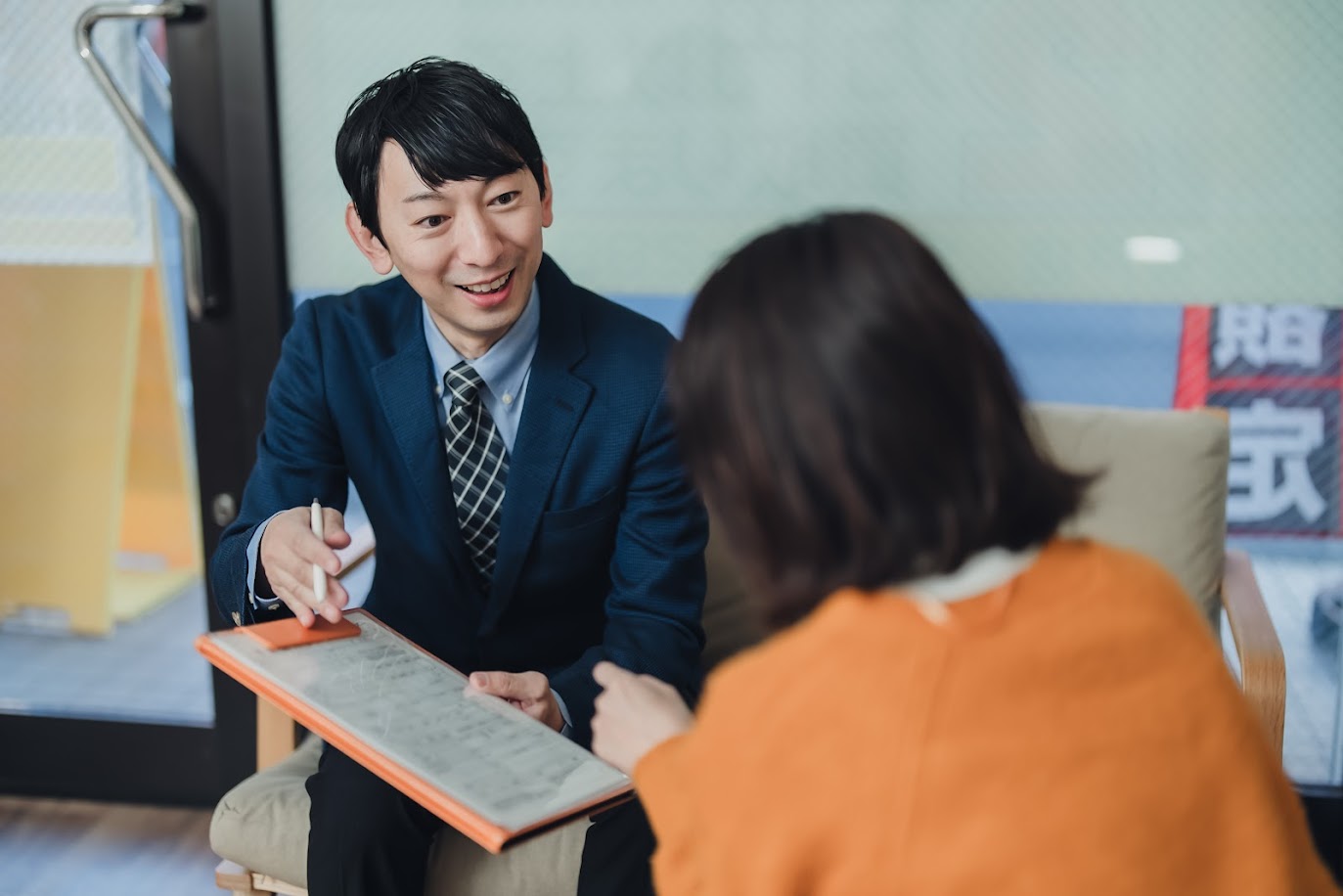 女性に契約書の説明をする男性ビジネスマン